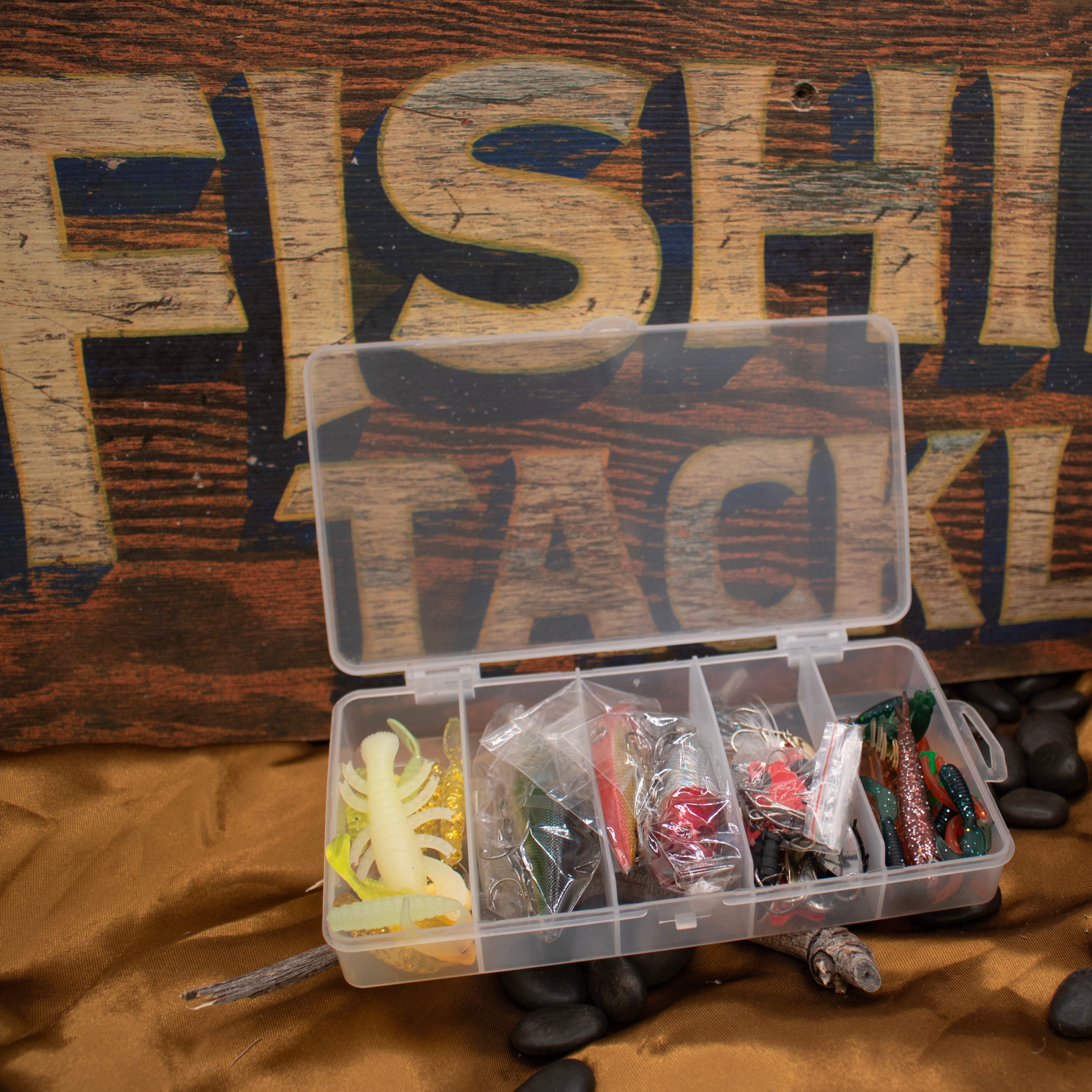 A collection of fishing lures Lures are inside an open clear plastic tackle box Fishing Lures Kit