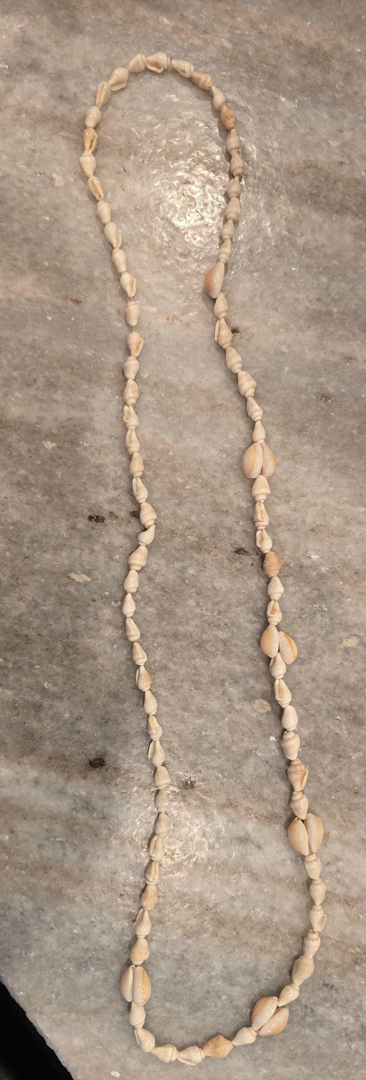 Handmade 24-inch necklace featuring genuine natural white and brown seashells strung in an alternating pattern, creating a lightweight coastal-inspired statement necklace.