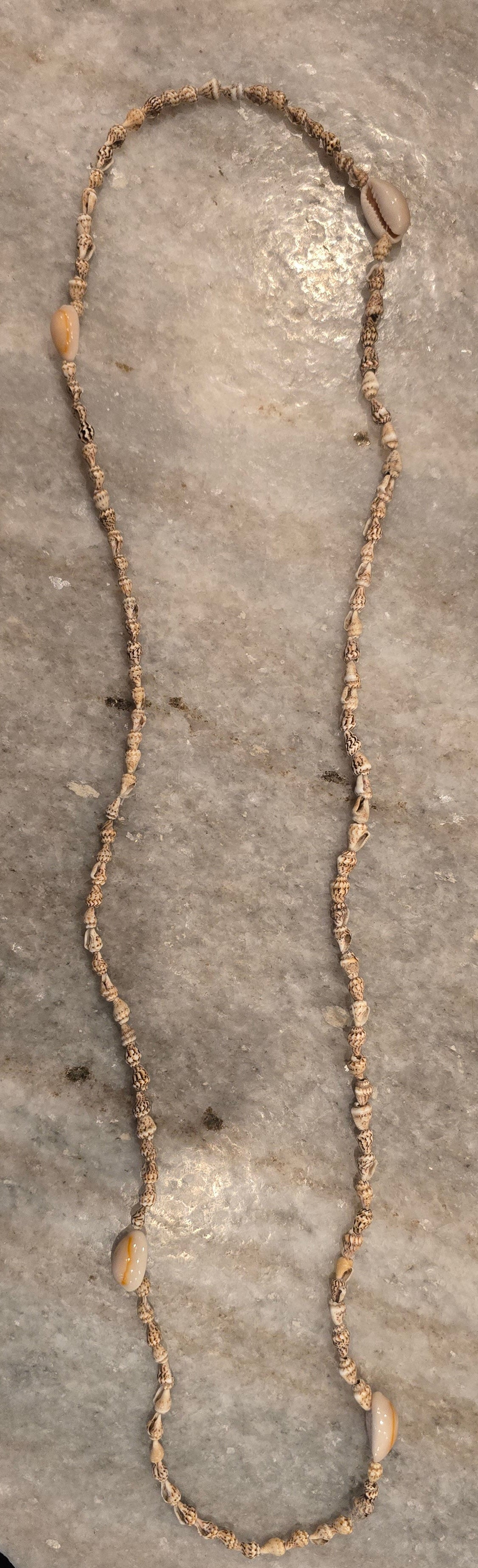 Handmade 24-inch necklace featuring genuine natural white and brown seashells strung in an alternating pattern, creating a lightweight coastal-inspired statement necklace.