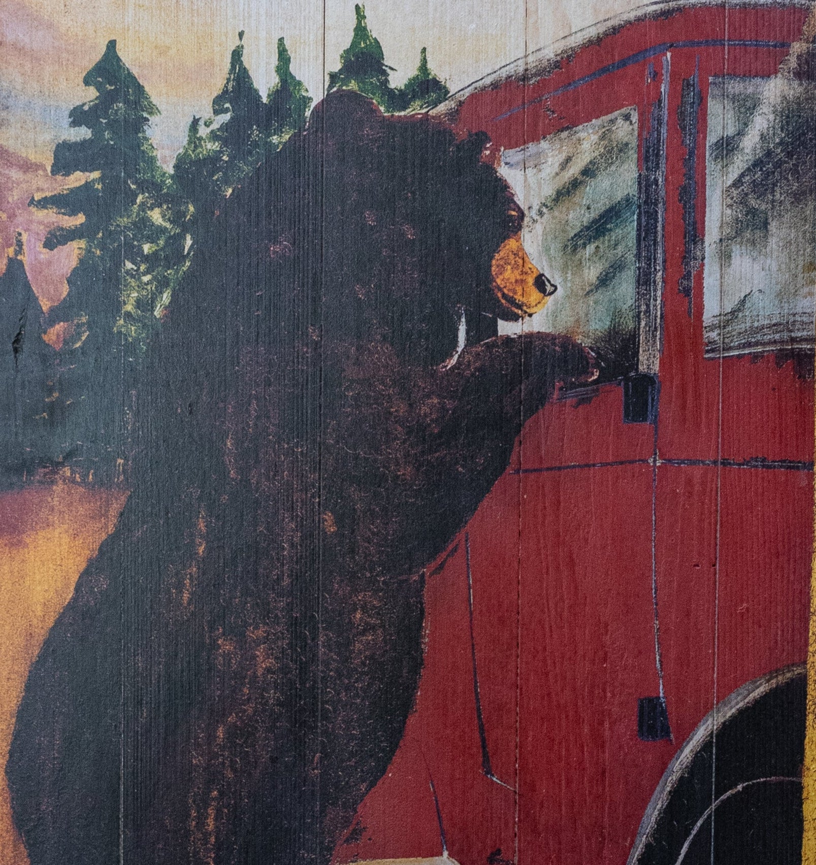 Wooden Plaque Depicting a Large Black Bear Hanging Off of a Red Car "Enjoy the Many Scenic Drives"