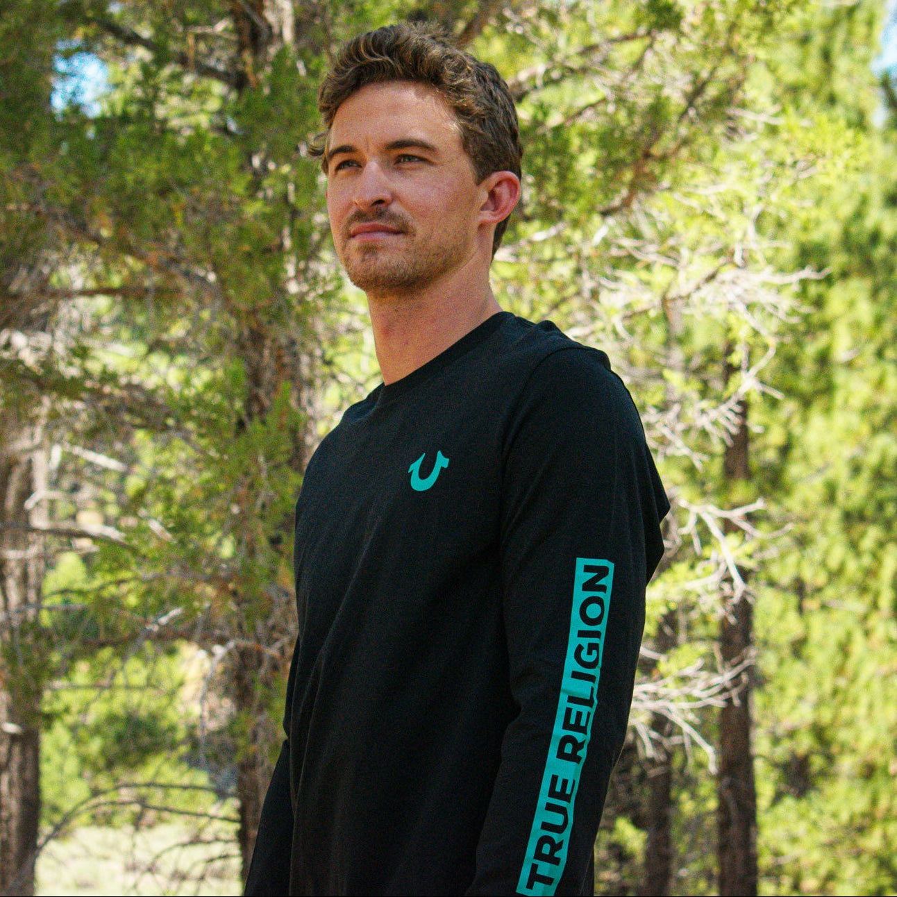 TRUE RELIGION long sleeve graphic tee in jet black with teal sleeve branding and large back graphic available in small medium large and XL sizes