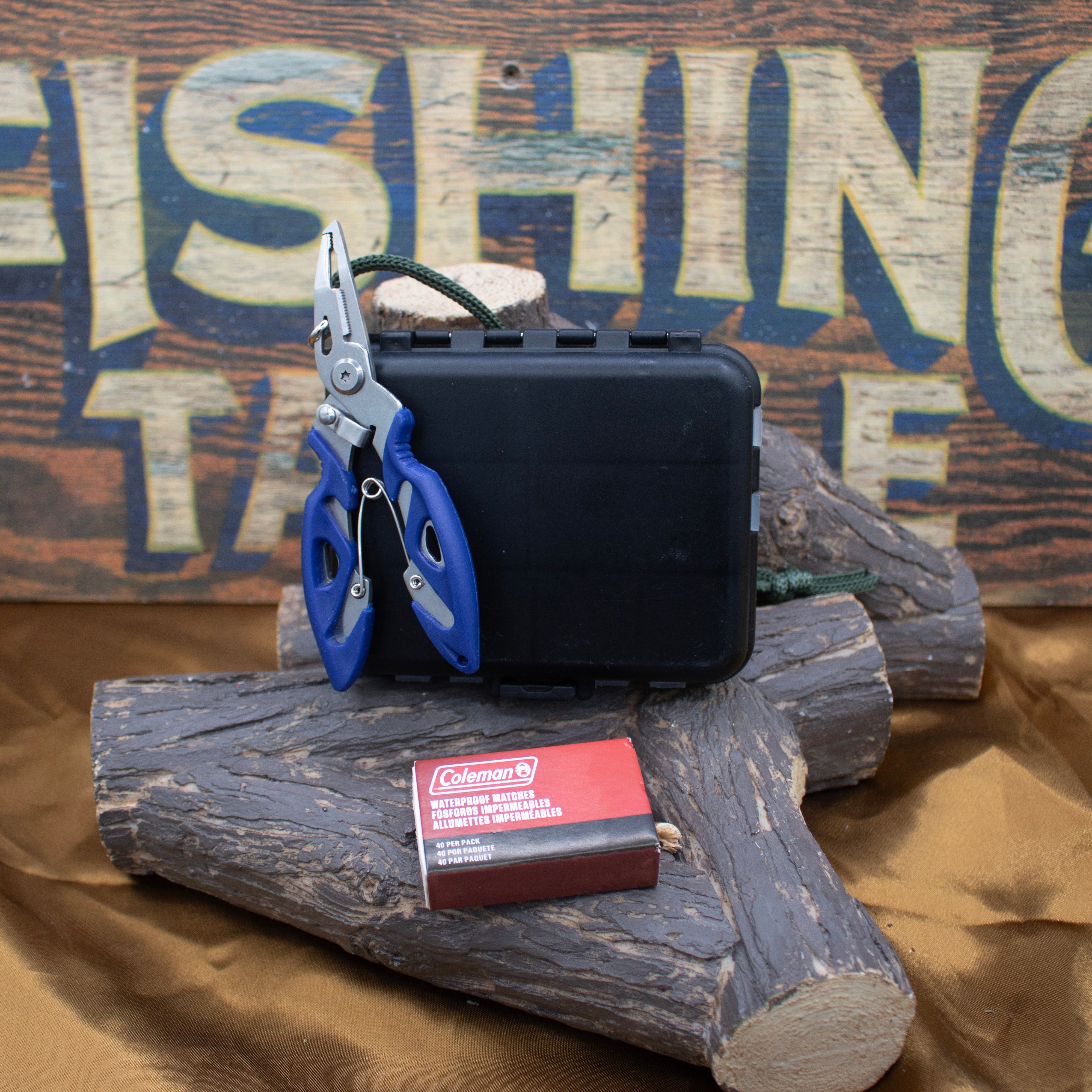 A collection of fishing accessories including a black plastic tackle box, needle nose pliers, various hooks and connectors, and weights. Fishing Accessories 188 Piece Kit