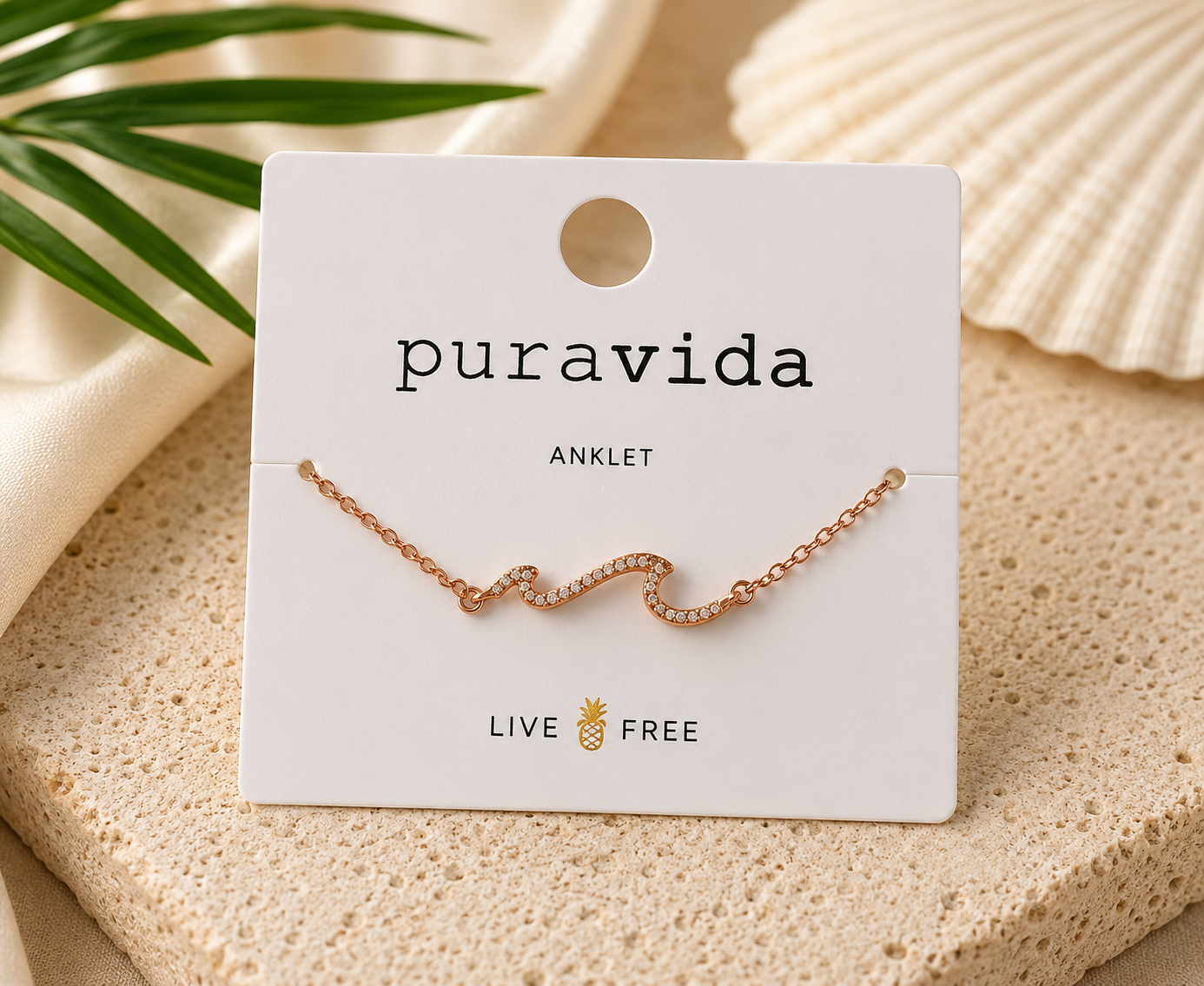 Authentic Pura Vida rose gold-tone anklet featuring a sparkling crystal wave centerpiece on an adjustable chain, displayed on the original Pura Vida anklet card, brand new and unworn.