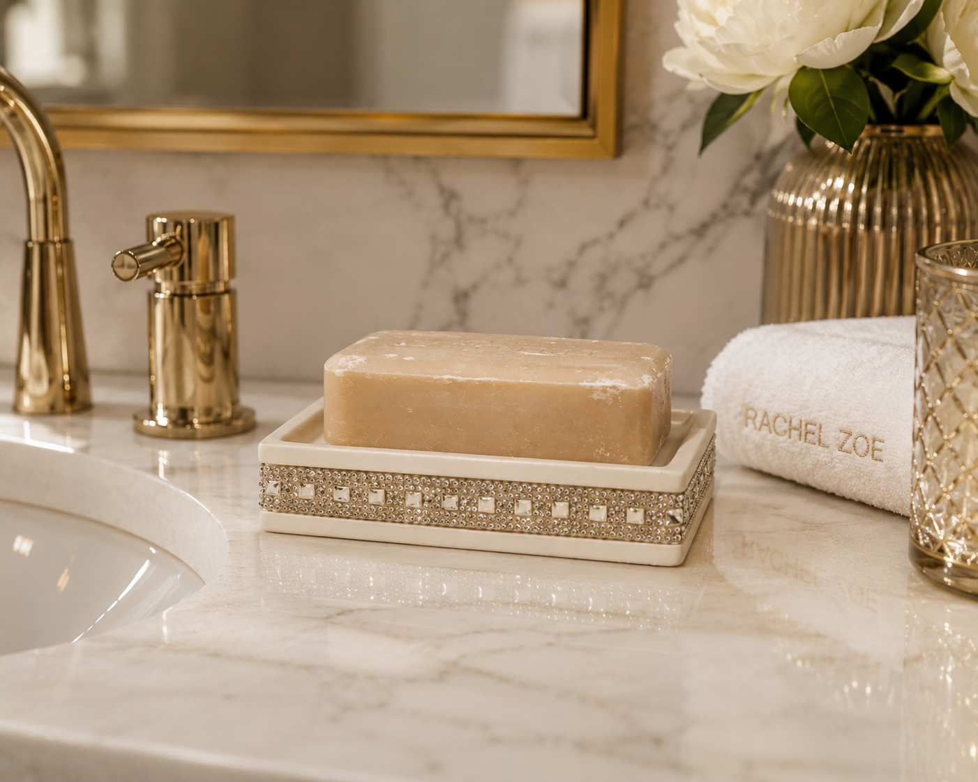 Rachel Zoe soap holder featuring an ivory finish with decorative crystal-style trim, displayed holding a bar of soap in an elegant bathroom setting.
