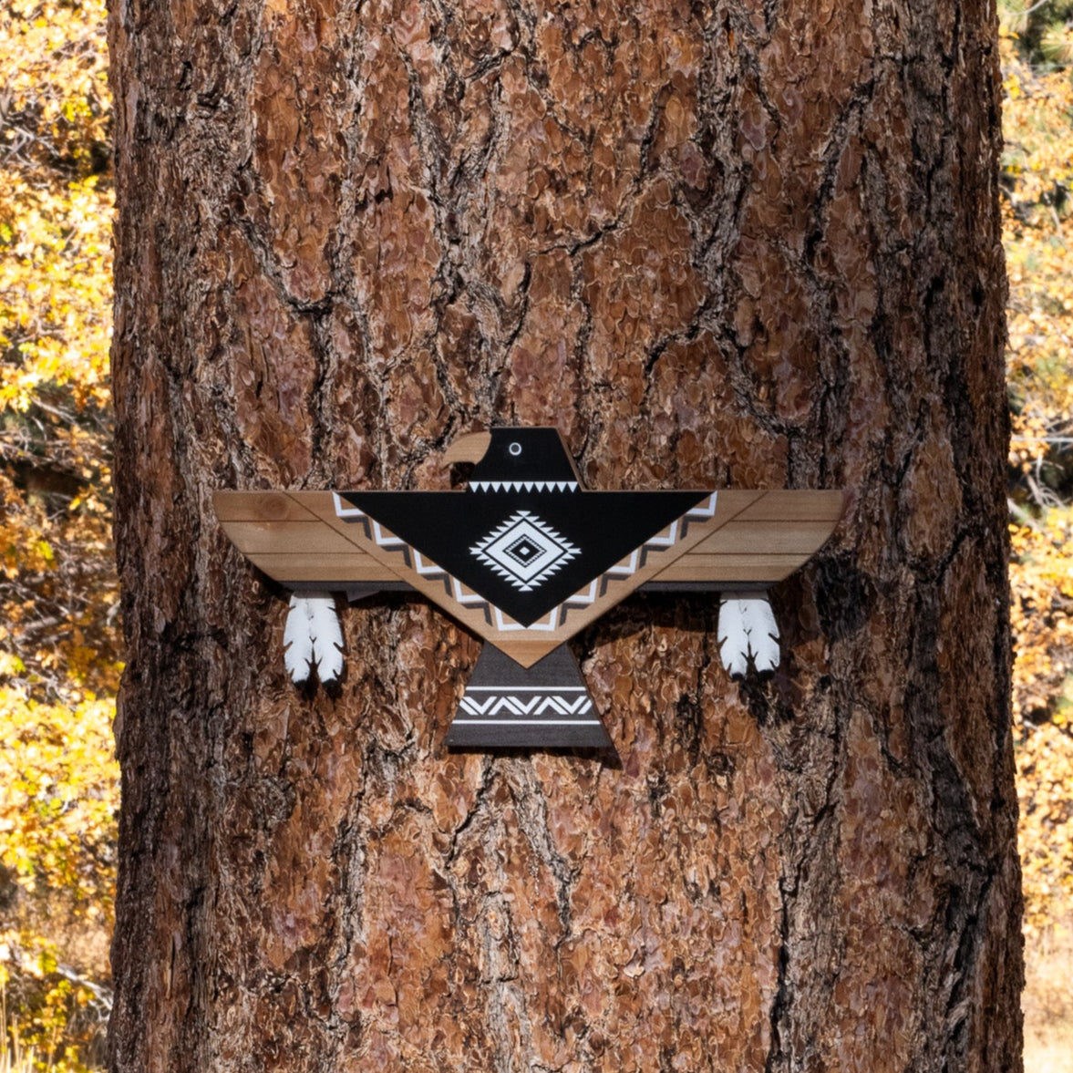 Lonestar Thunderbird wooden wall art featuring black, white, and natural wood geometric Southwestern patterns with decorative feather accents, measuring 18 inches wide by 10 inches high.