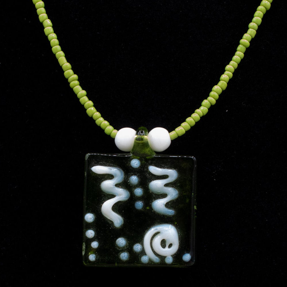 A Green Glass Pendent Adorned on a Dainty Green Beaded Necklace