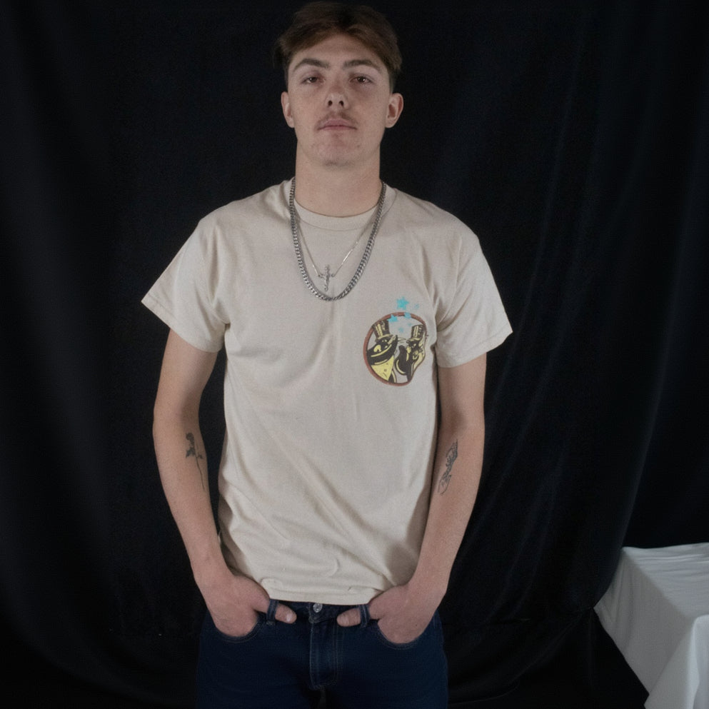 The off-white Fleetwood Mac Graphic T-shirt is available in a men's Medium size and features two penguins wearing top hats on the front and back.