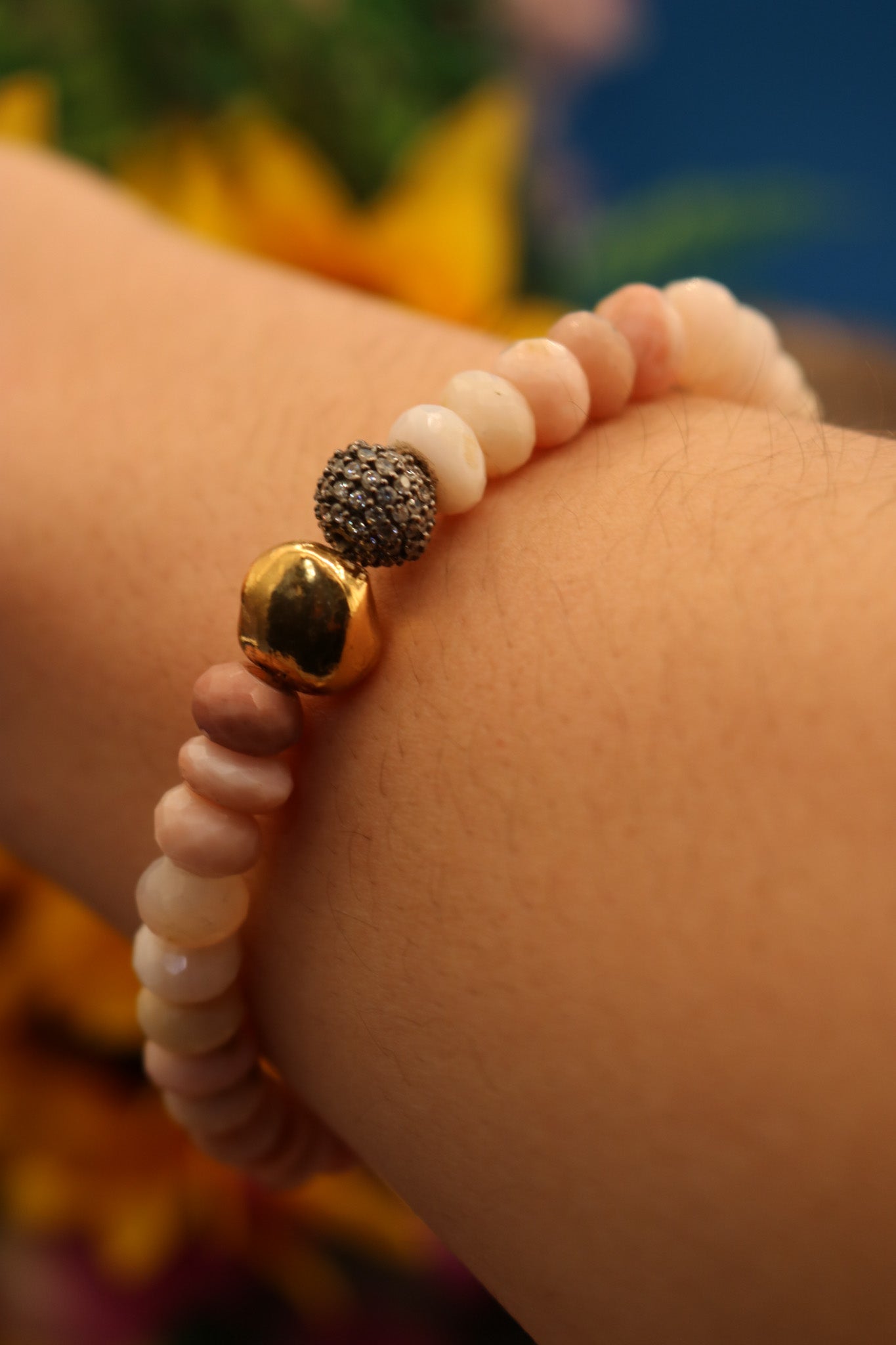 Calming Pink Opal Stone Bracelet Adorned with a Single Gold Bead and another Bead Embellished with Small Rhinestones.