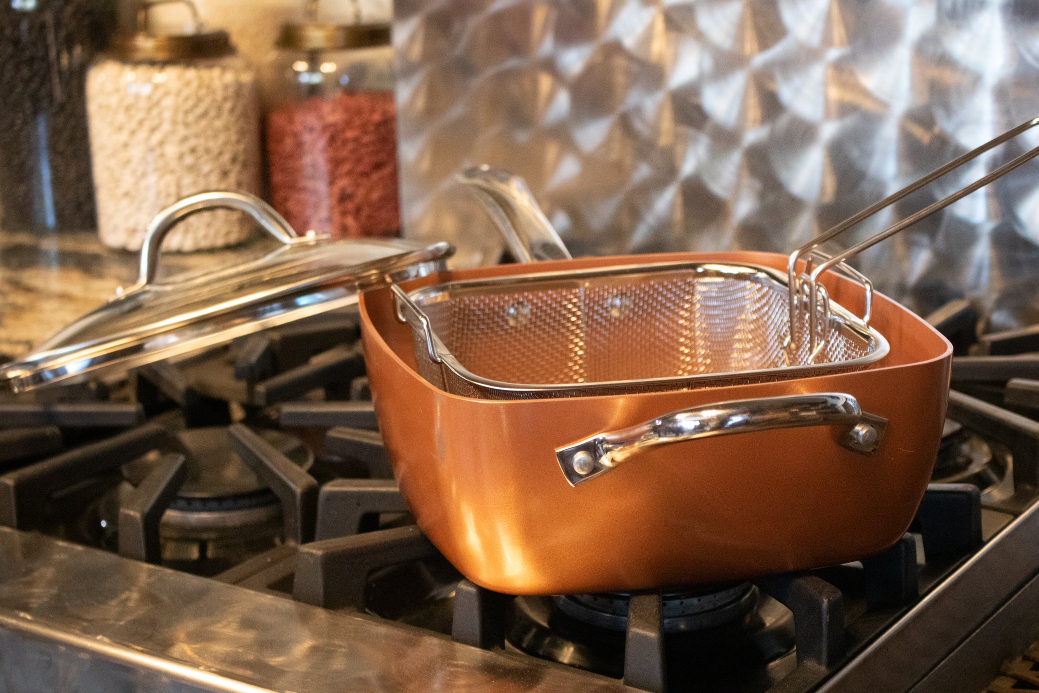 Copper Chef square nonstick copper pan with matching lid and removable stainless steel deep fry basket on stovetop