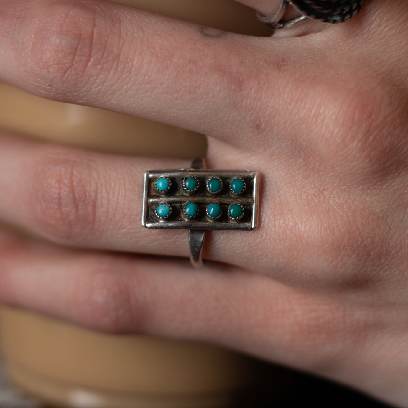 Eight Mini Turquoise Gemstones Aligned in Rows Along a thin Sterling Silver Ring Size 7