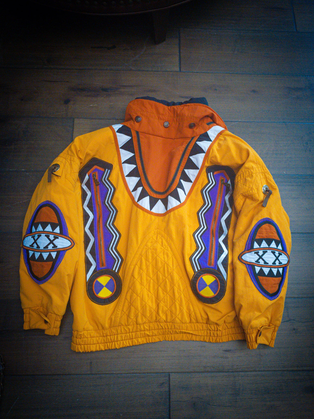 Back of the Bogner Goan Thylmann jacket laid flat with burnt orange hood panel and quilted center