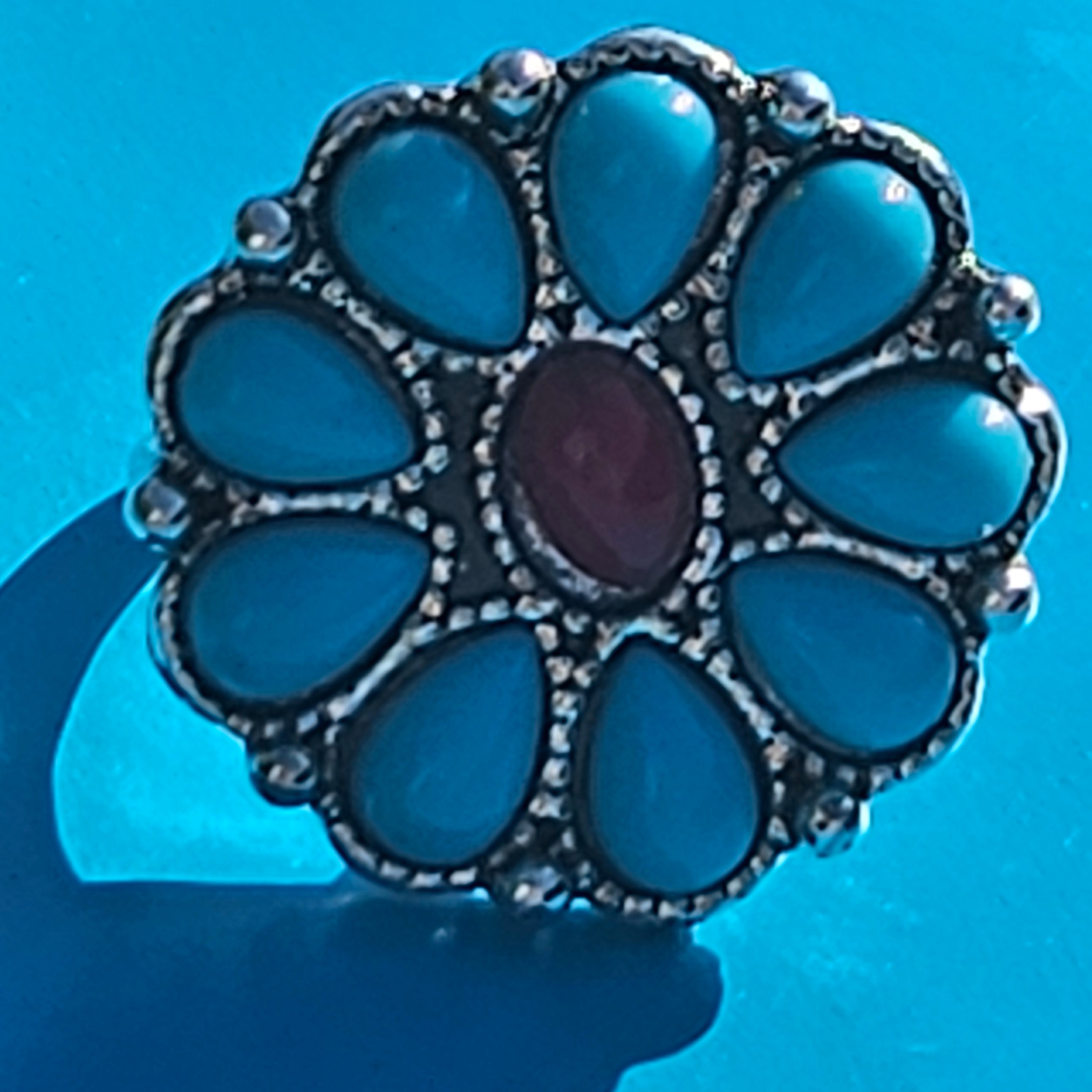 Large silver plated flower statement ring featuring faux turquoise teardrop stones with a red center stone in a Southwestern boho design, size 6.