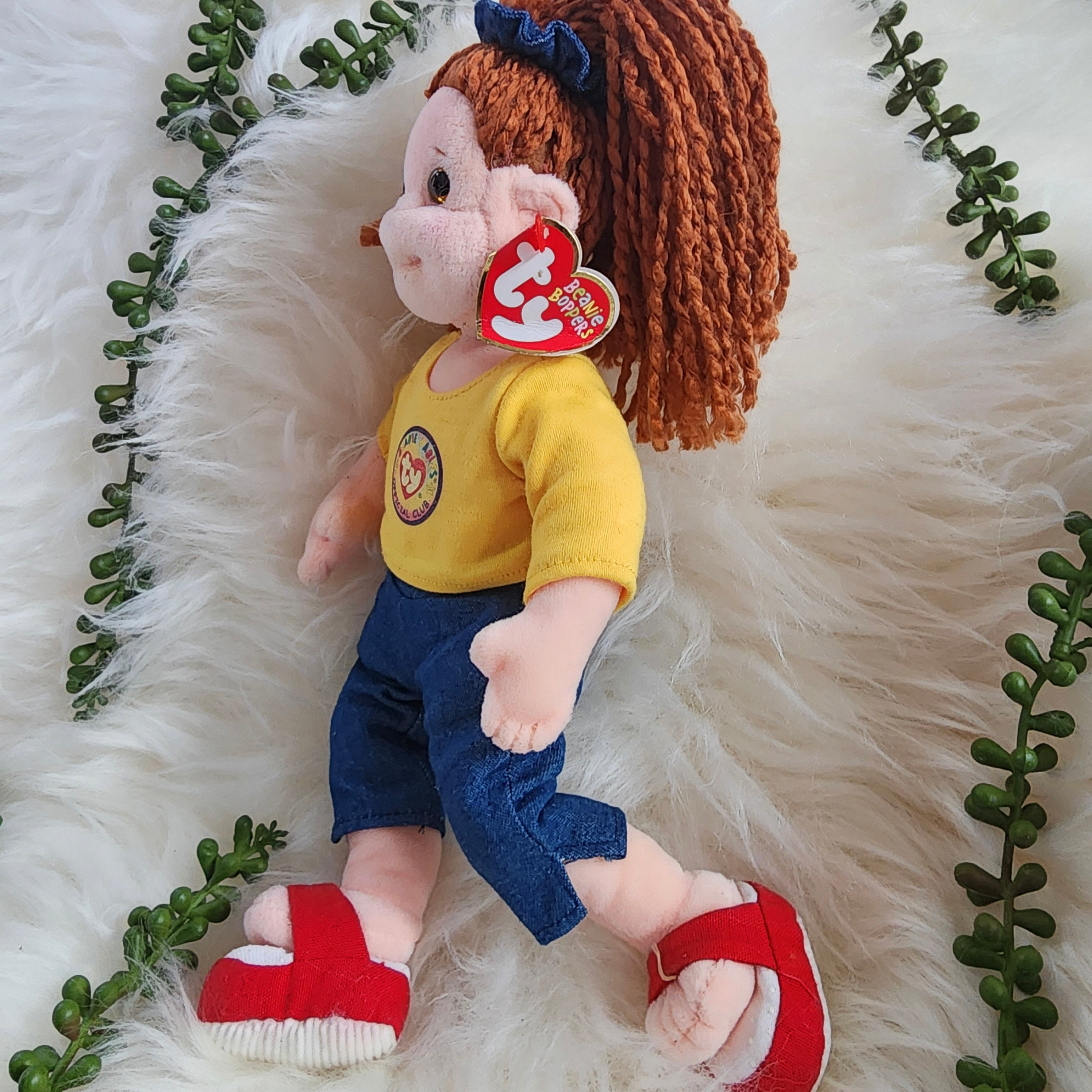 Ty Beanie Babies 'Cuddly Crystal', a large plush doll with brown hair, wearing a yellow shirt, blue jeans, and red shoes