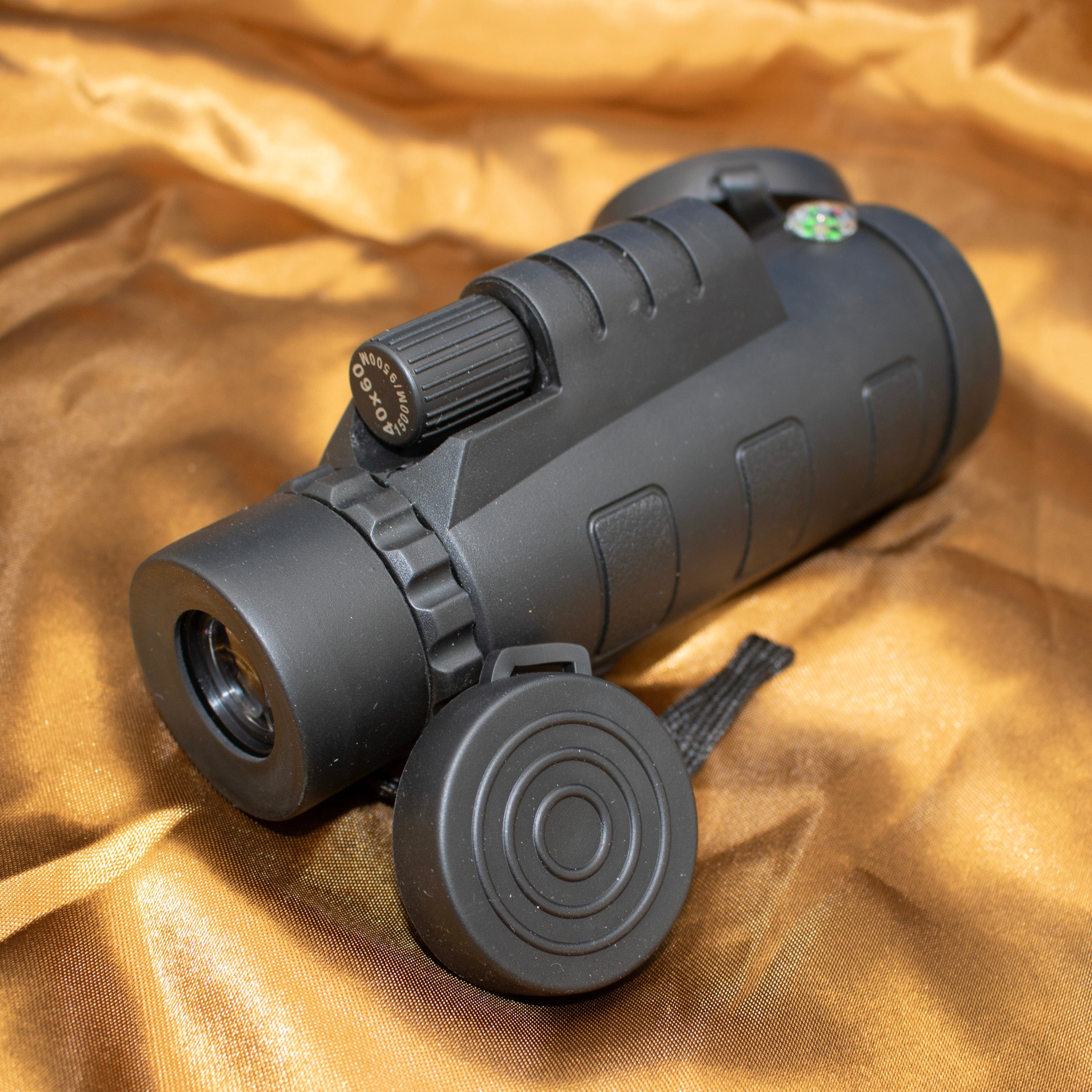 A monocular with a built-in compass comes with a black vinyl carrying bag. Monocular with Compass