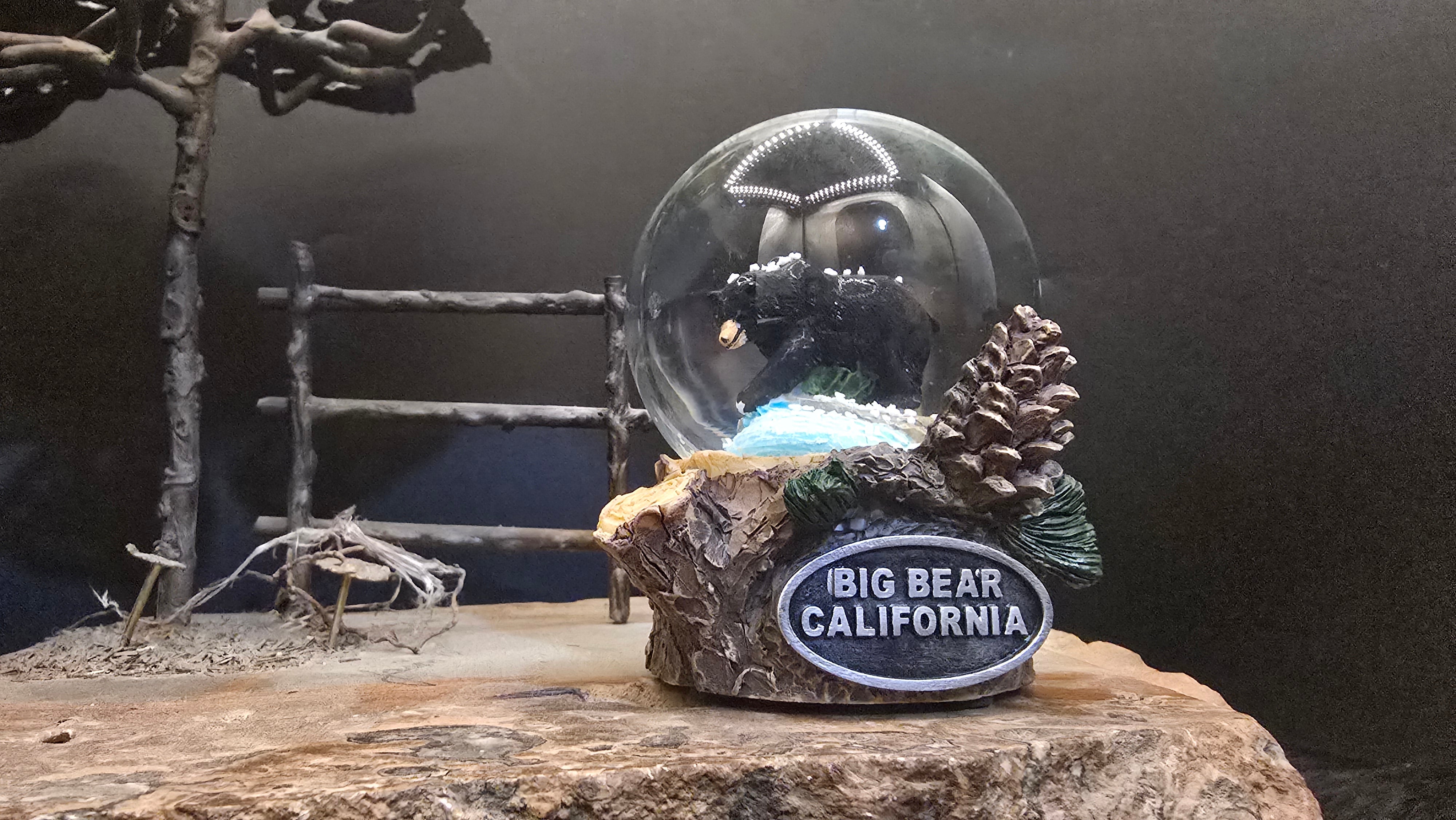 big bear california rustic snow globe with black bear figure and pinecone themed base measuring 3.5 inches tall
