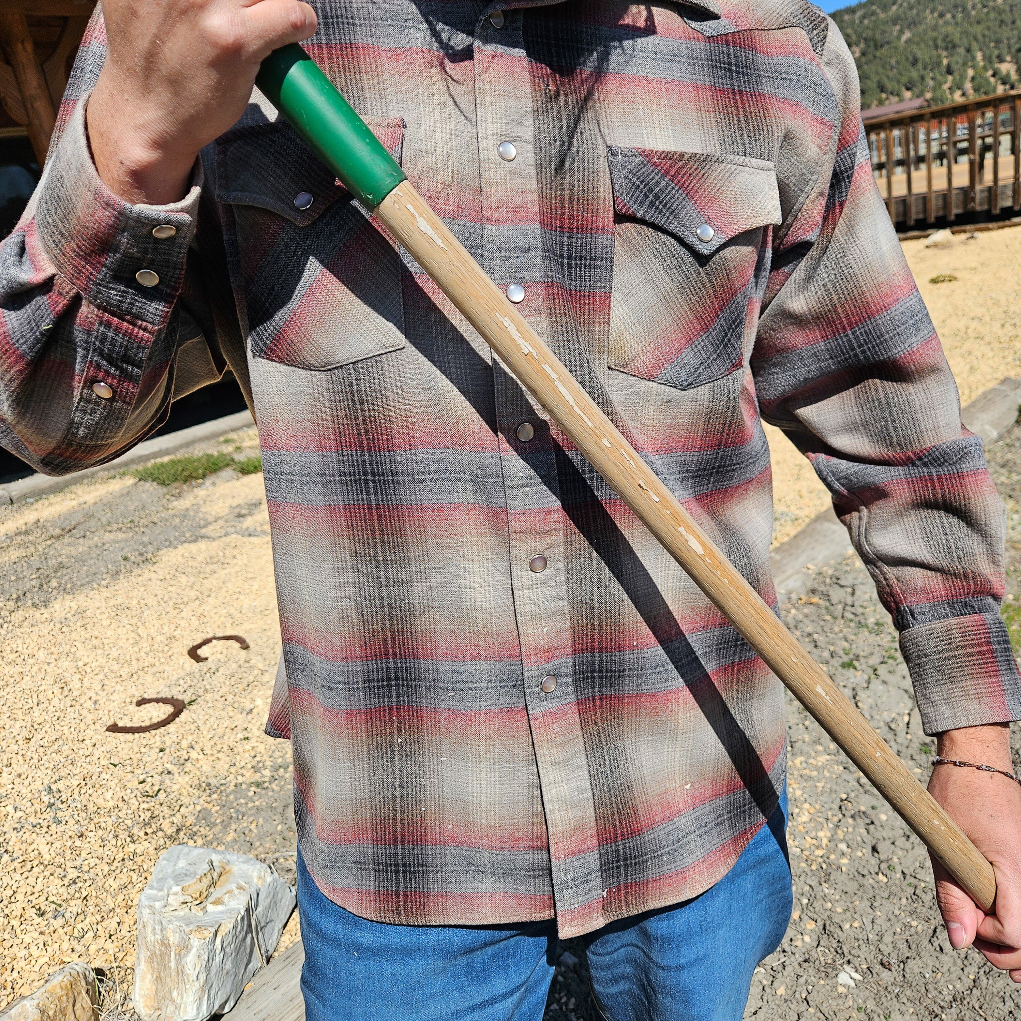 A person wearing a Pendleton Vintage Plaid 100% Wool Long sleeved Shirt Button-Down Flannel in colors red, blue, tan, and gray
