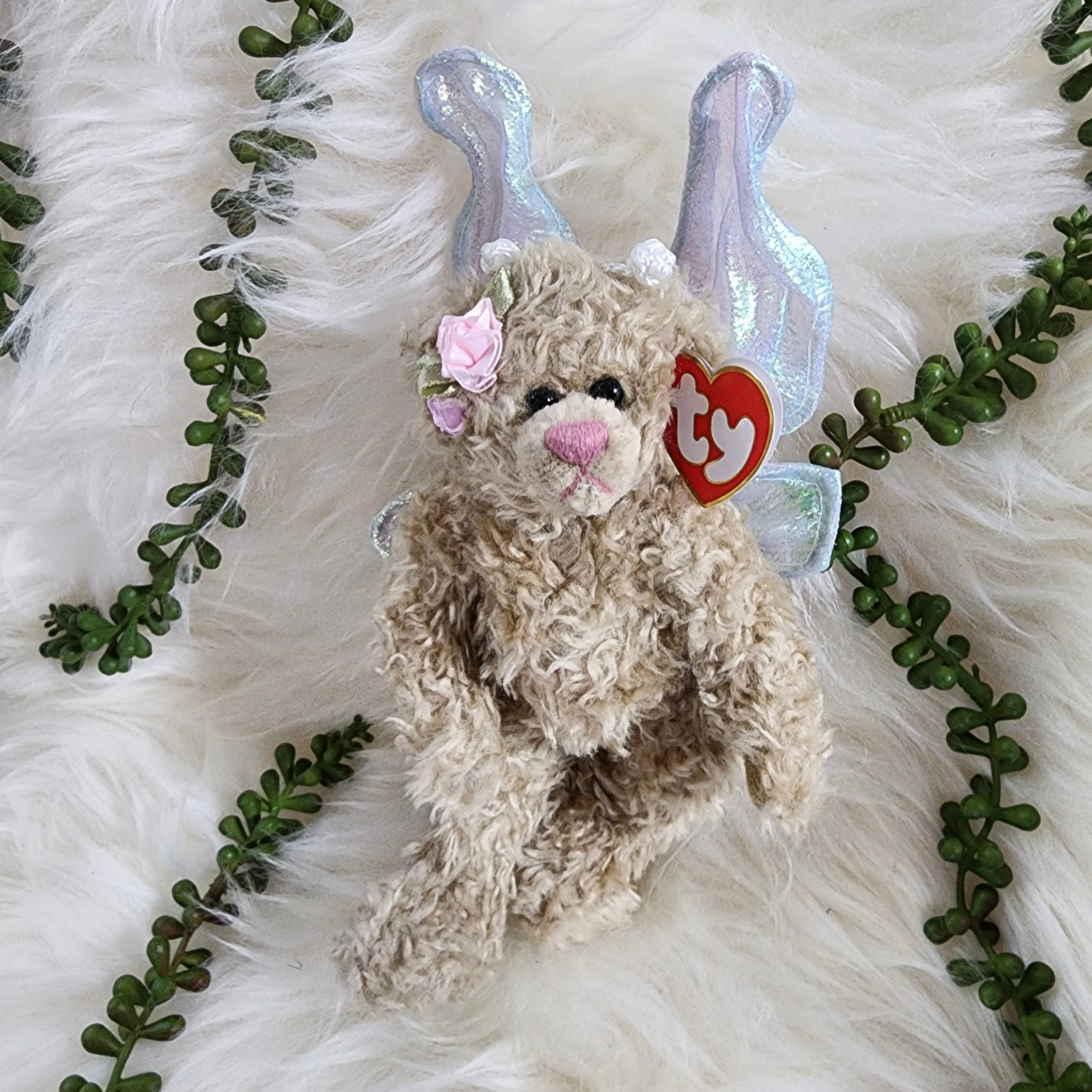 Ty Beanie Babies 'Rafaella the Bear' is a plush bear with rainbow silver wings