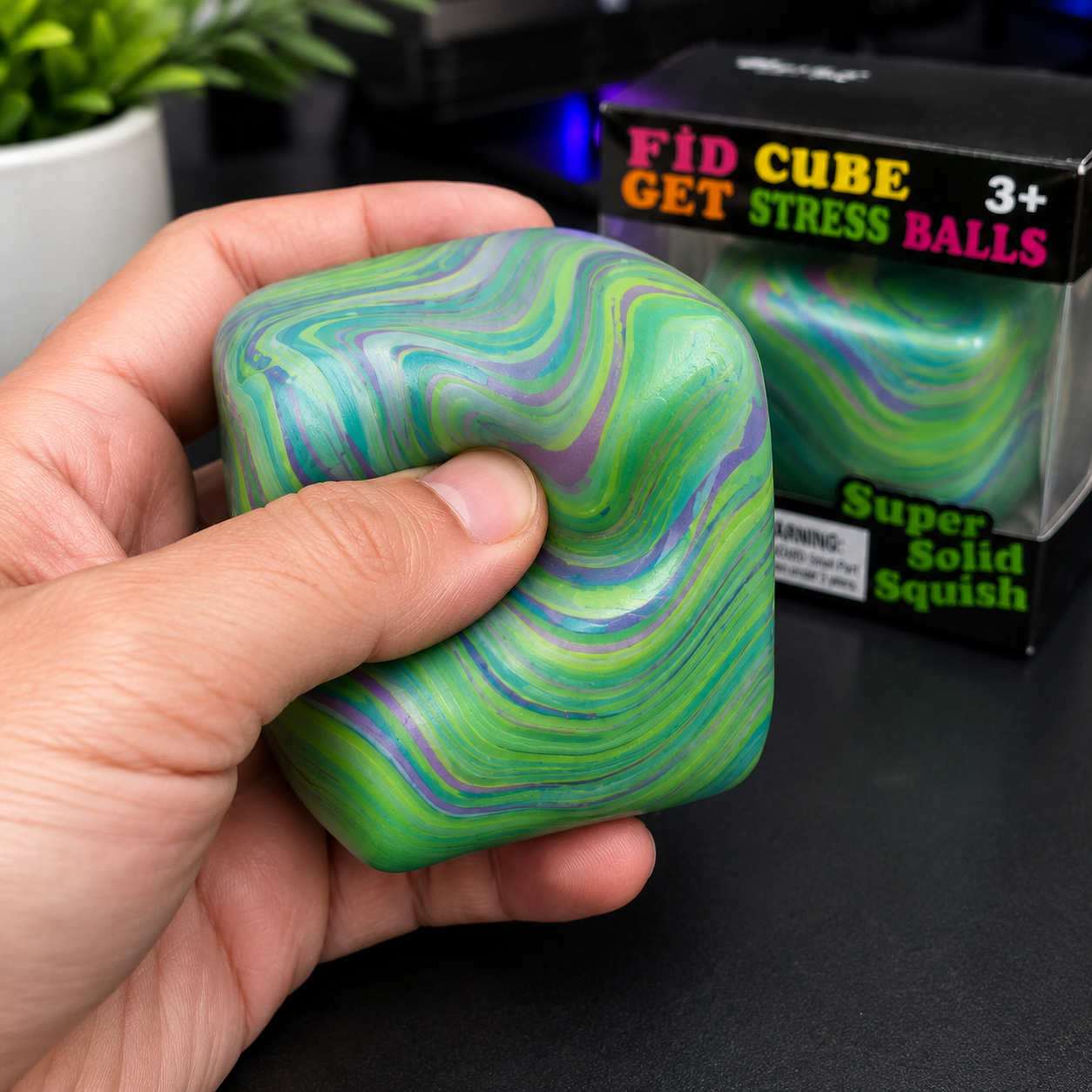 Marble swirl squishy stress ball in green, purple, and blue colors displayed in its original retail packaging labeled "Super Solid Squish."