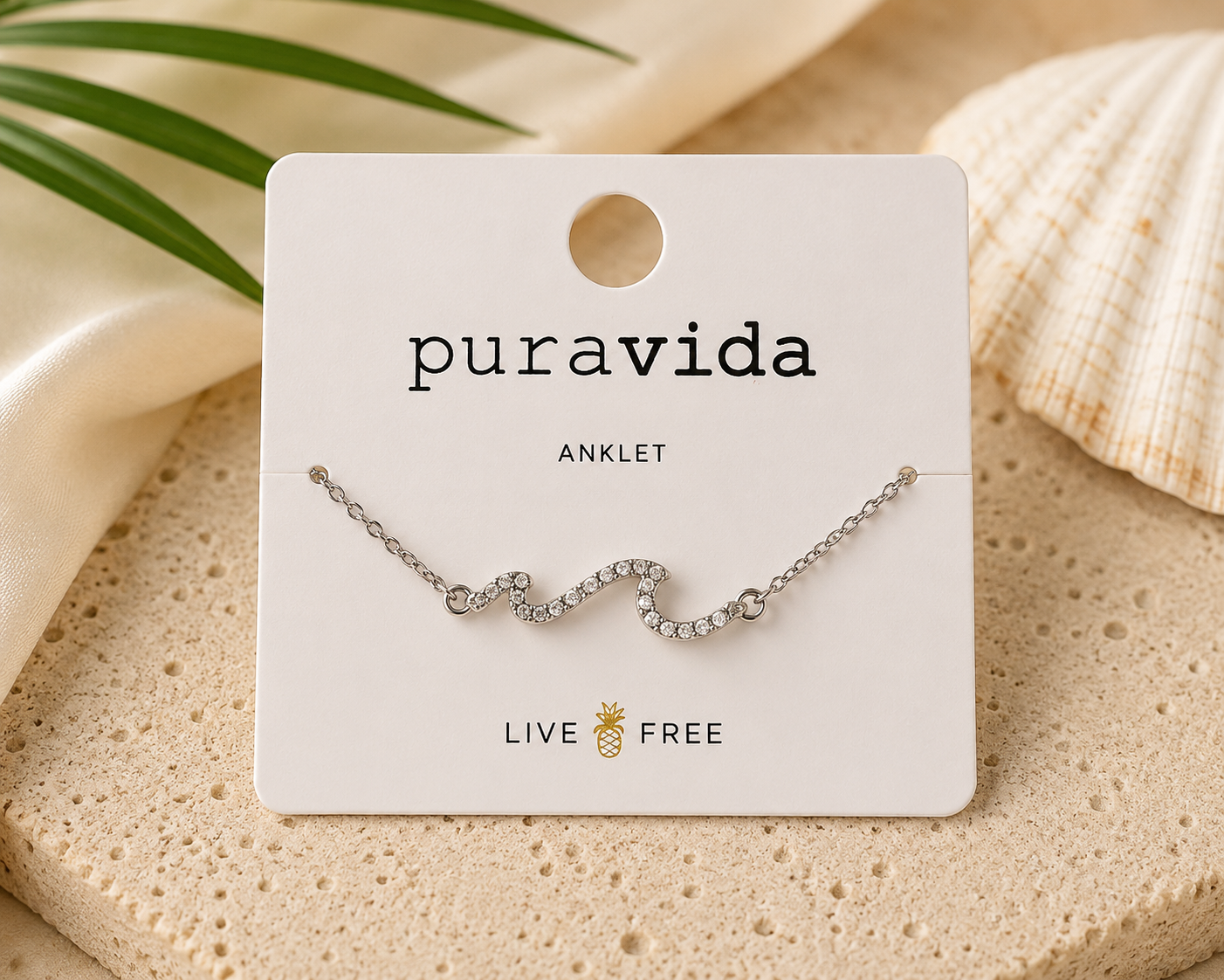 Authentic Pura Vida silver-tone adjustable anklet featuring a sparkling crystal wave centerpiece on a delicate chain, new on original branded display card.