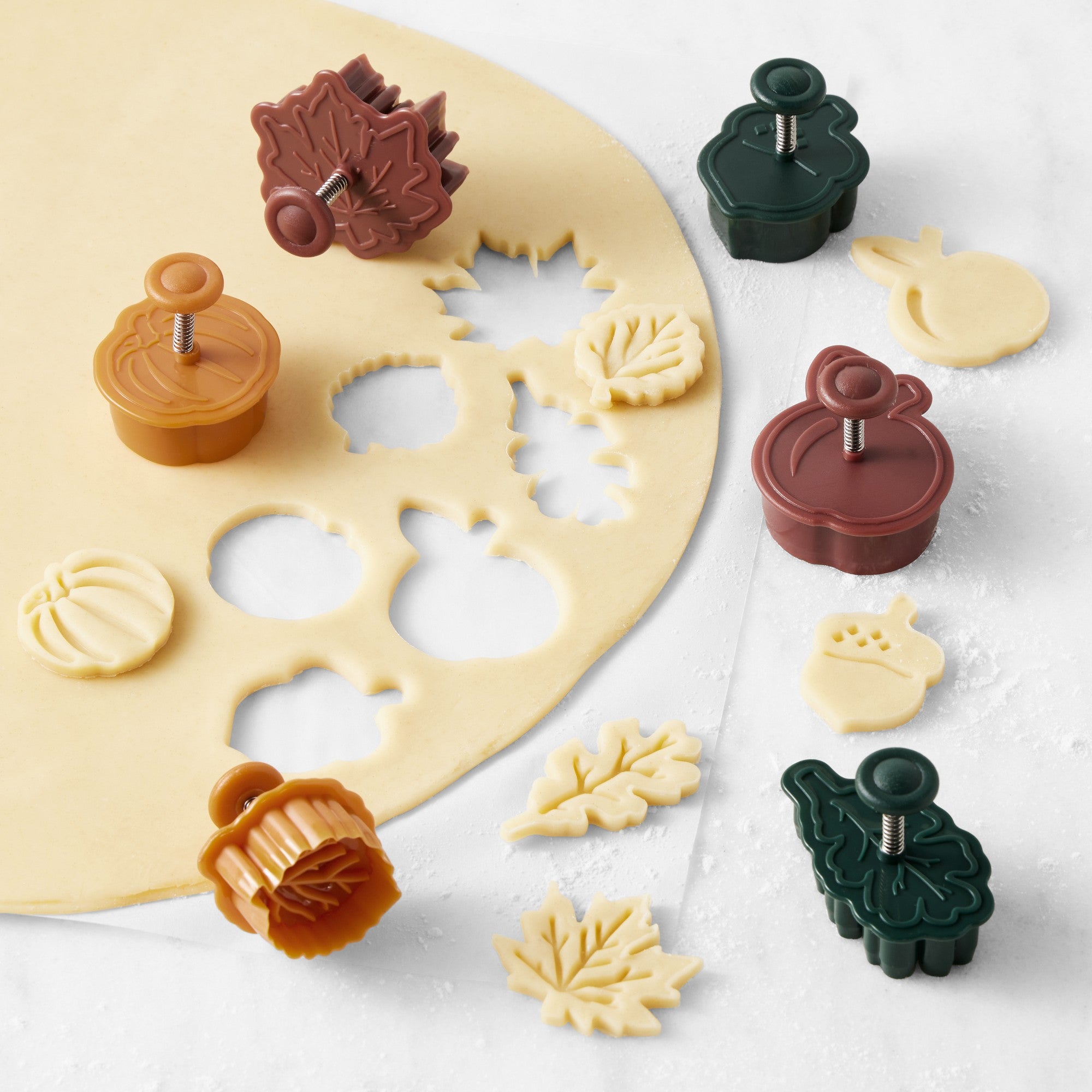 Williams Sonoma Autumn Pie Crust Cutters Set of 6 featuring pumpkin, apple, acorn, oak leaf, and maple leaf shapes for fall pie and cookie decorating.