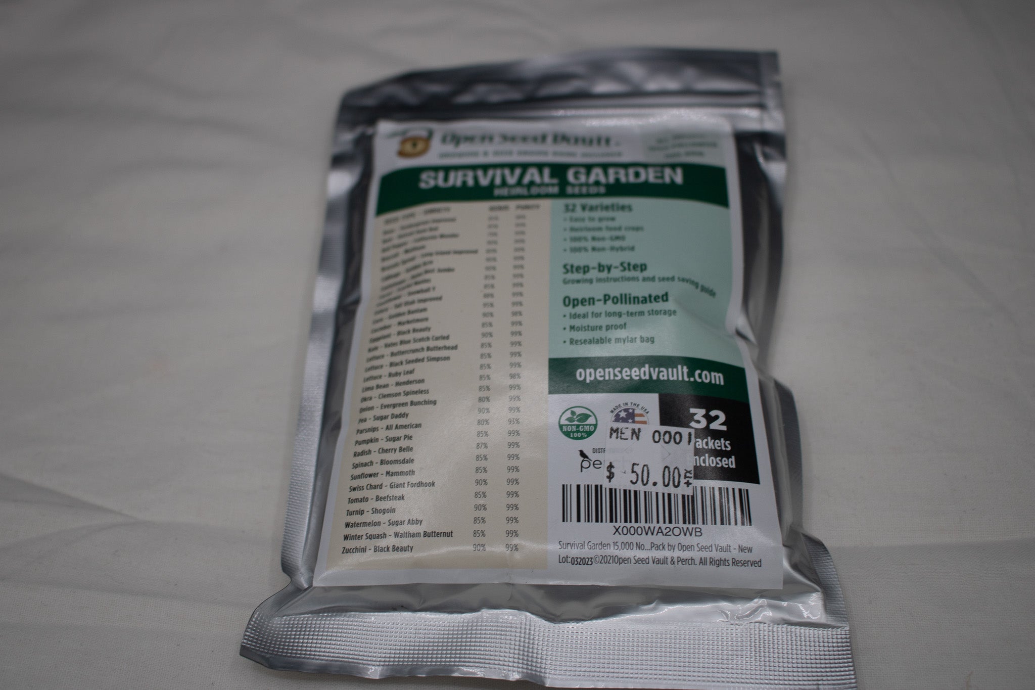 Open Seed Vault Survival Garden heirloom seed collection featuring over 15,000 non-GMO seeds across 32 vegetable, fruit, and herb varieties packaged in a resealable mylar storage pouch for gardening and emergency preparedness.
