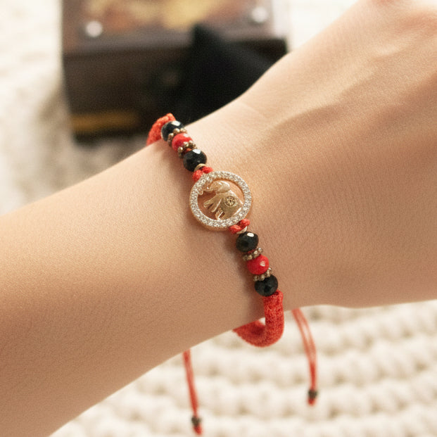 Red Braided Jute Cord Bracelet with Gold Colored Zirconia Elephant Charm