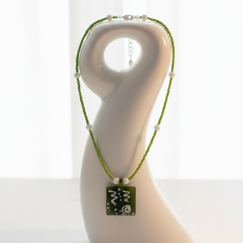 A Green Glass Pendent Adorned on a Dainty Green Beaded Necklace