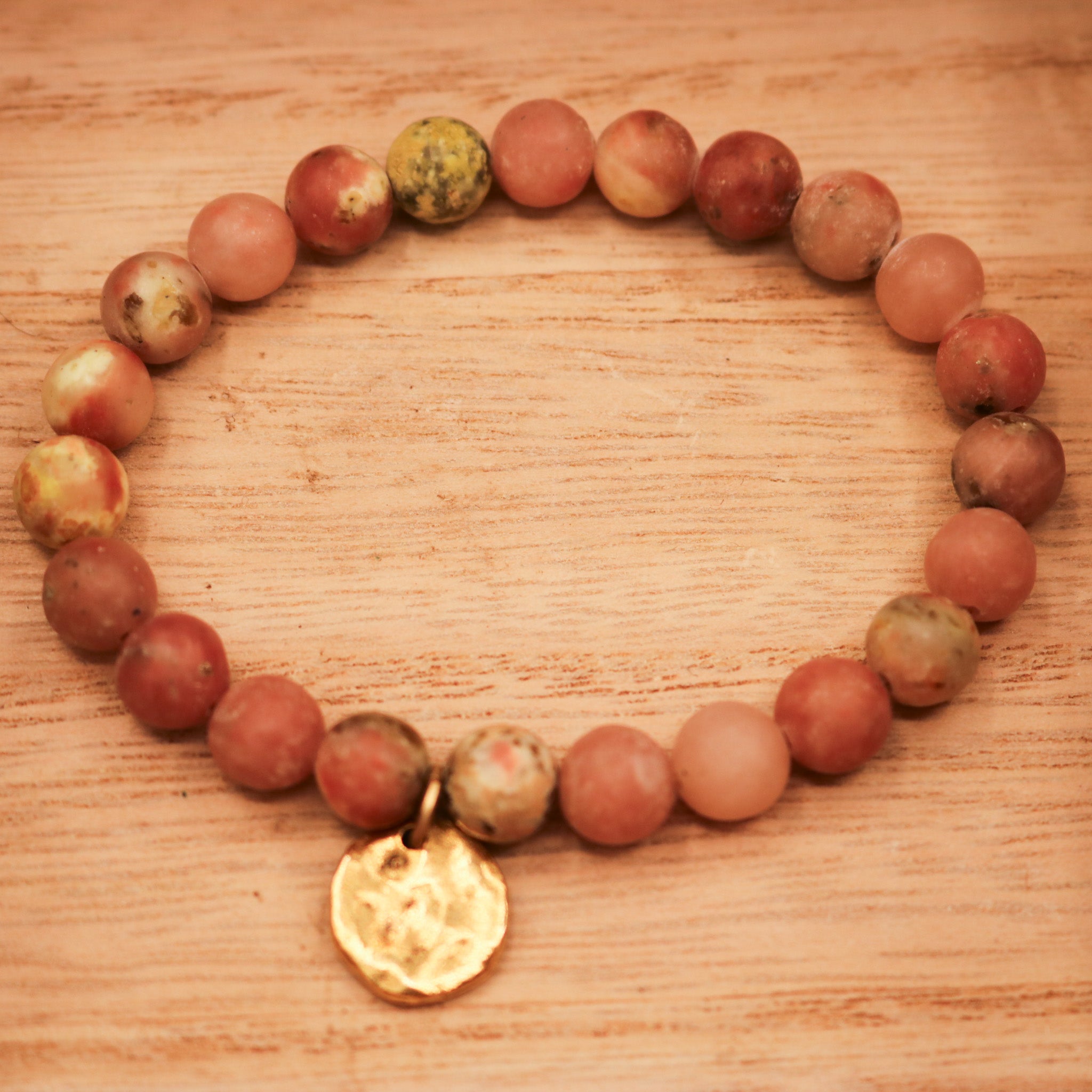 Natural Pink Stone Elastic Bracelet Featuring a Gold Charm