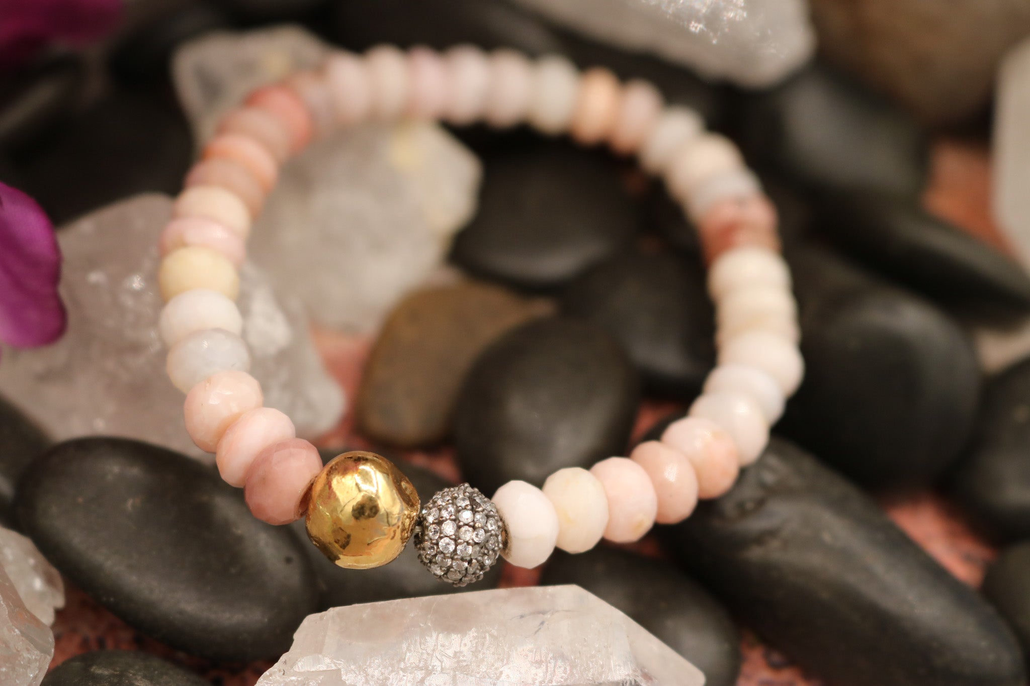 Calming Pink Opal Stone Bracelet Adorned with a Single Gold Bead and another Bead Embellished with Small Rhinestones.