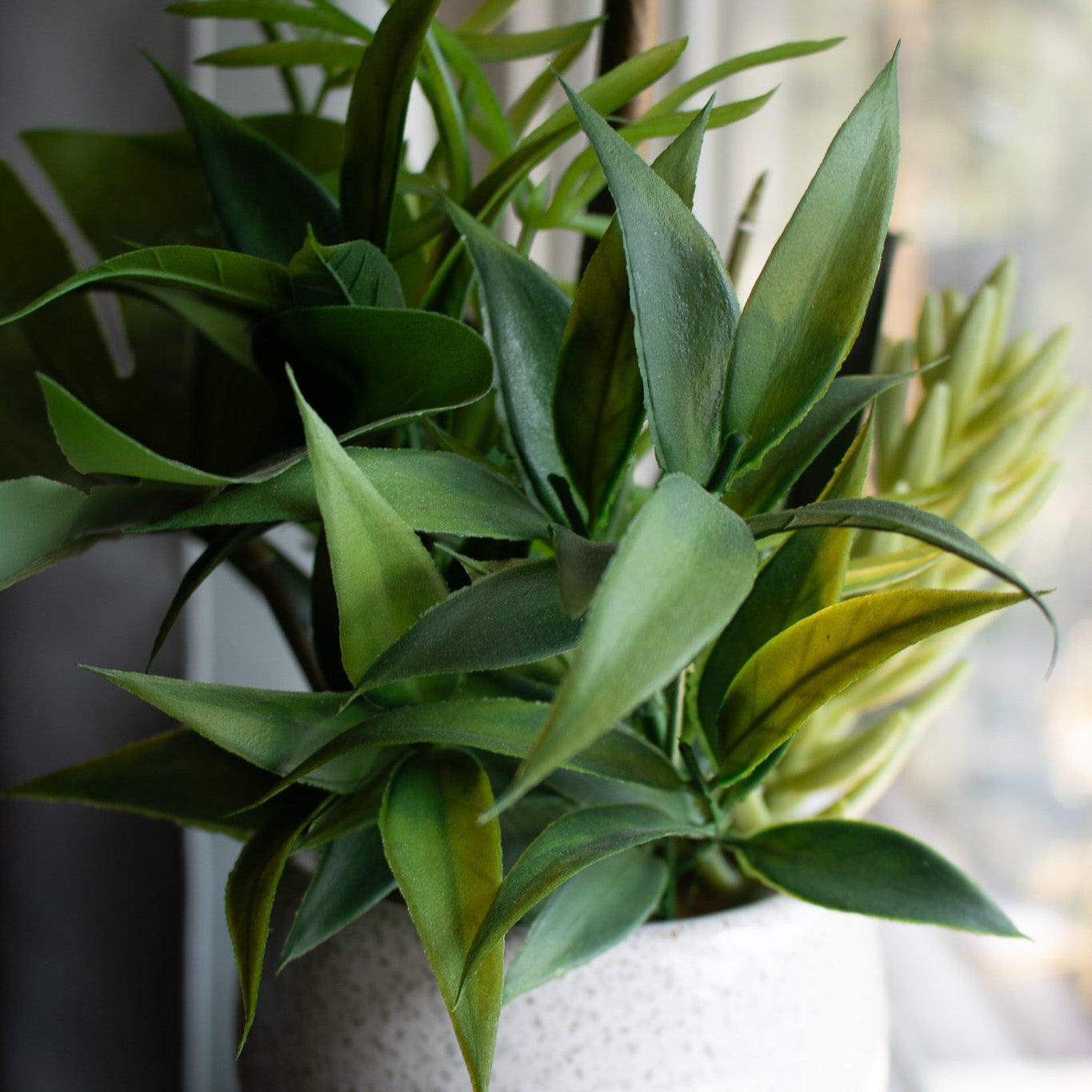 Elegant House Garden Faux White Orchid with Lush Greenery in Stylish Ceramic Vase
