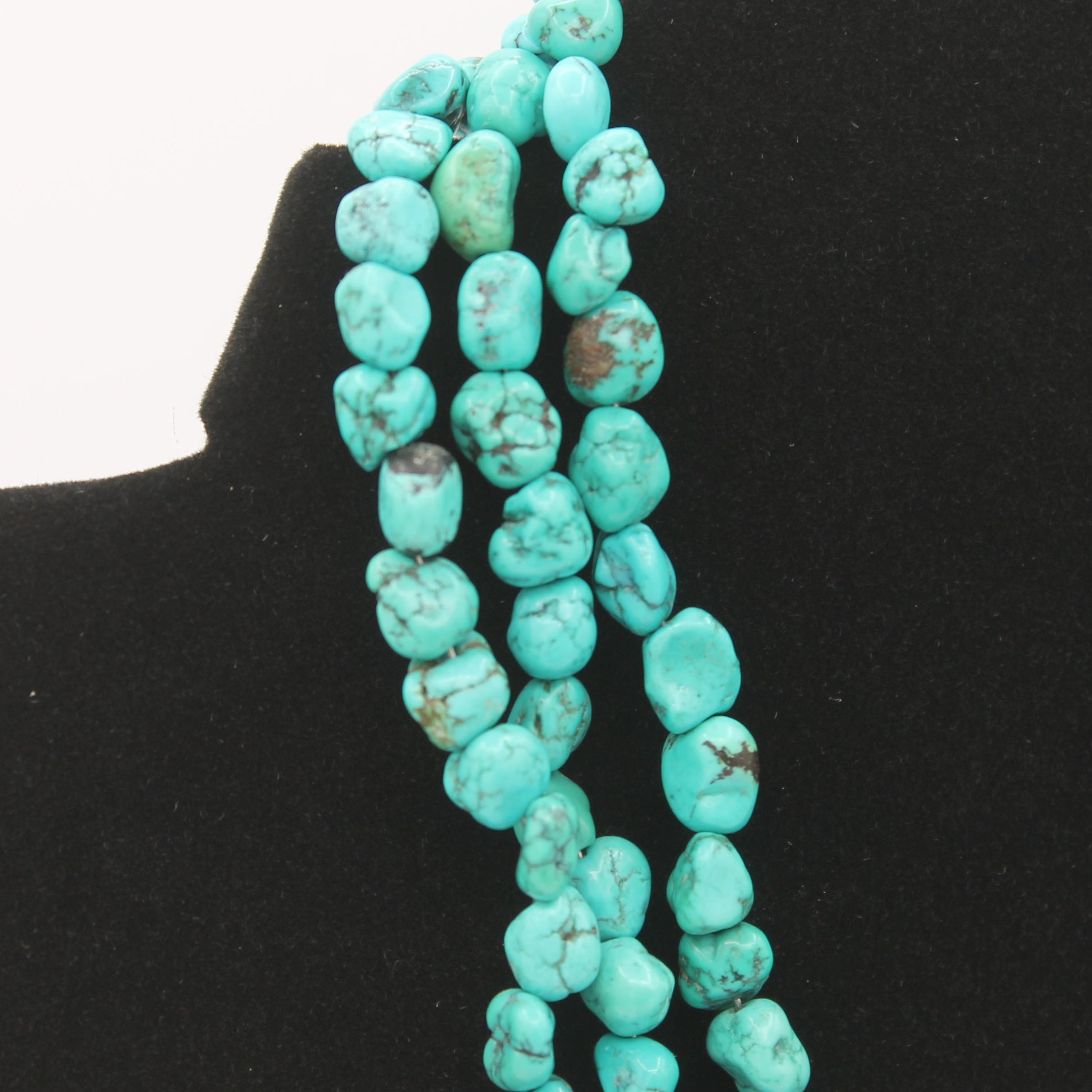 Vintage Navajo Turquoise Nugget Triple Strand Necklace with a Sterling Silver Toggle Clasp.