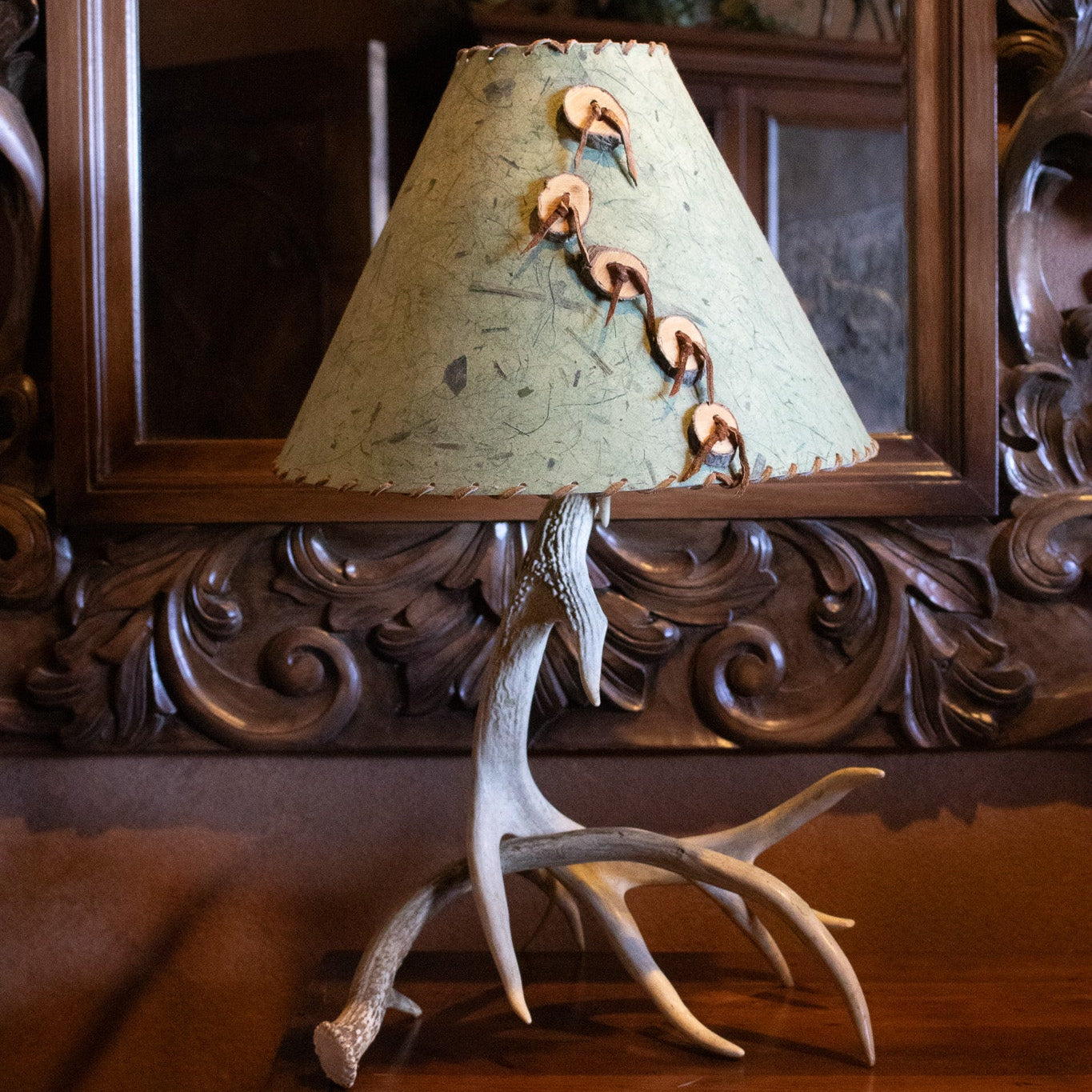 Classic Elk Horn Lamp Complemented by a Green Patterned Shade