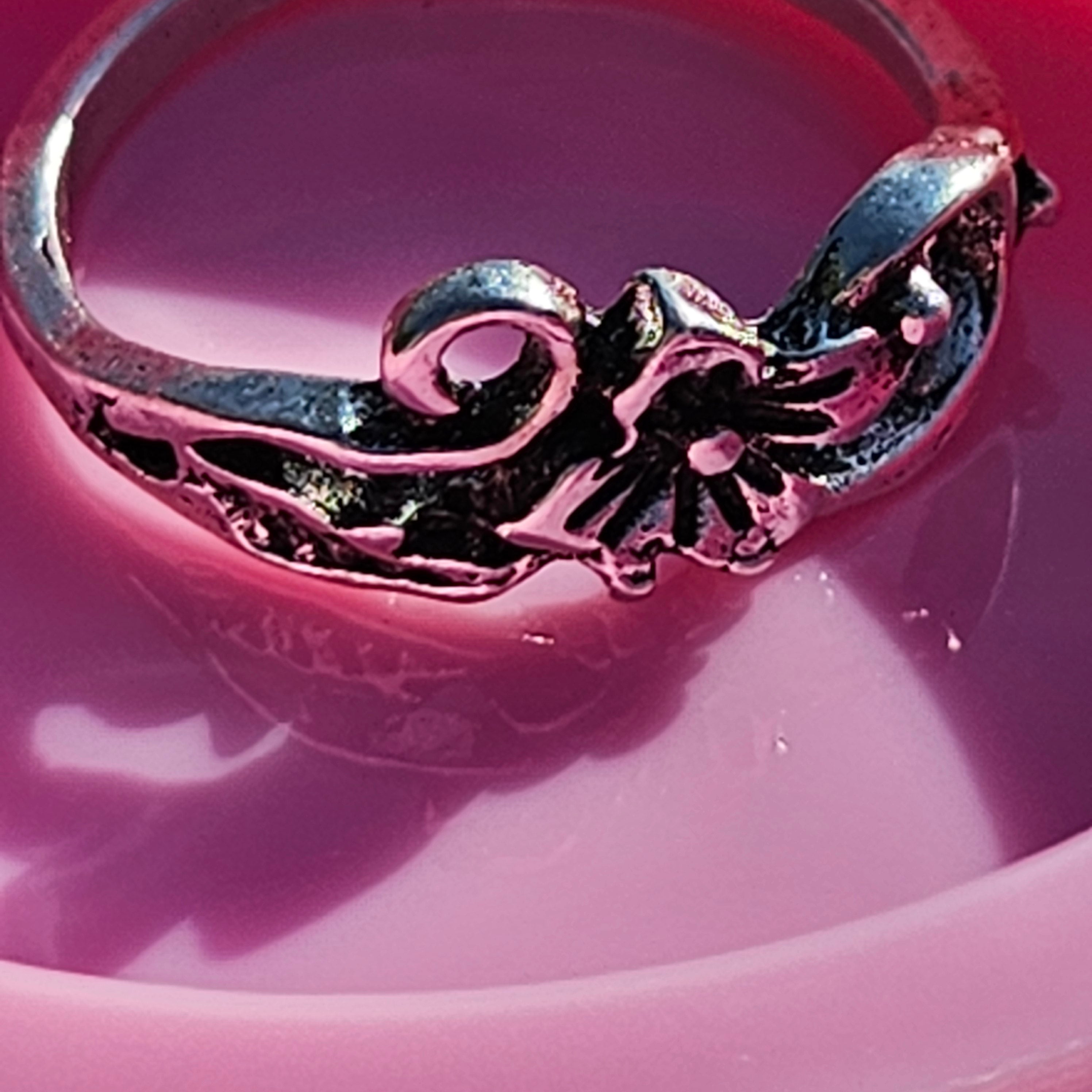 Vintage silver plated floral ring featuring a lily flower centerpiece with ornate filigree scroll detailing, size 6.